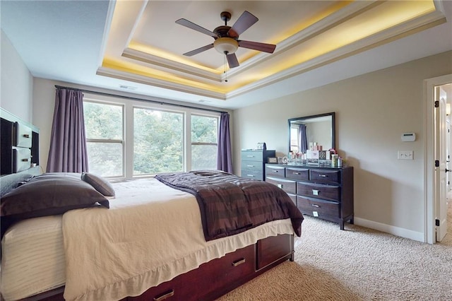 bedroom featuring light carpet, ceiling fan, a raised ceiling, and crown molding