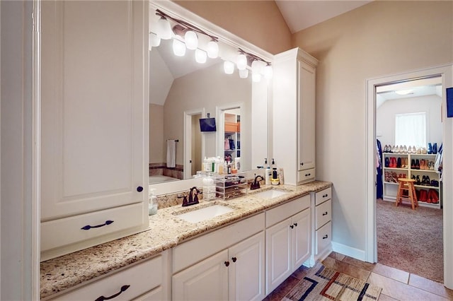 bathroom featuring lofted ceiling, vanity, and tile patterned floors