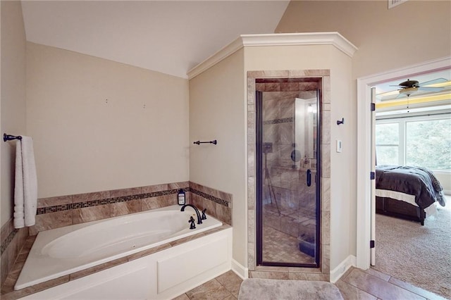 bathroom featuring shower with separate bathtub, lofted ceiling, ceiling fan, and tile patterned floors