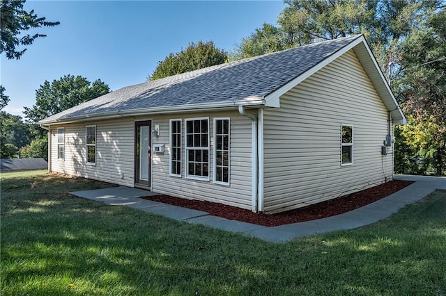 view of home's exterior with a yard