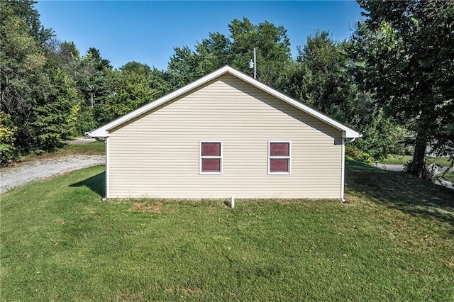 view of side of home featuring a lawn