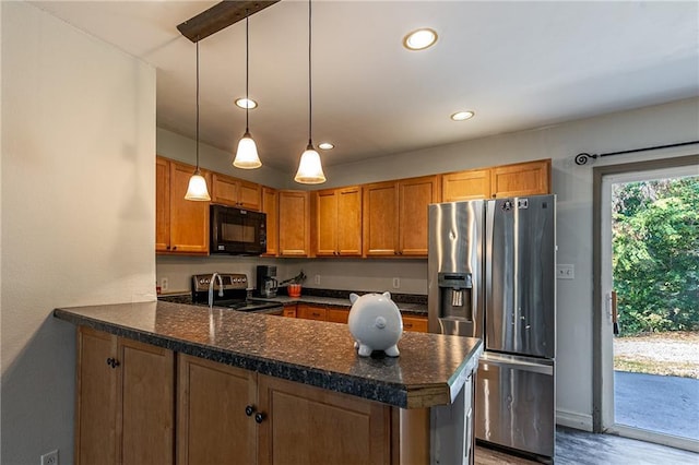 kitchen featuring a peninsula, recessed lighting, appliances with stainless steel finishes, decorative light fixtures, and brown cabinets