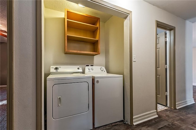 laundry area with washer and dryer, laundry area, dark wood-style floors, and baseboards