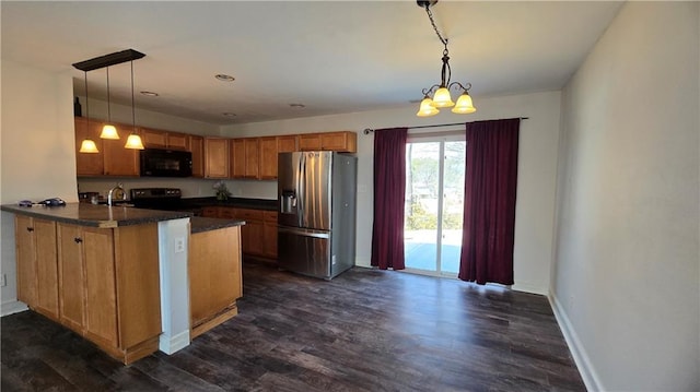 kitchen featuring electric range, dark countertops, a peninsula, black microwave, and stainless steel fridge with ice dispenser