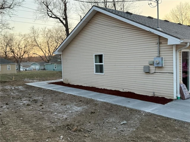 view of home's exterior with a shingled roof