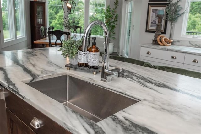 room details with light stone counters and sink