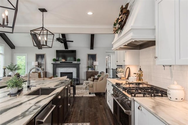 kitchen featuring white cabinetry, hanging light fixtures, stainless steel appliances, dark hardwood / wood-style floors, and custom exhaust hood