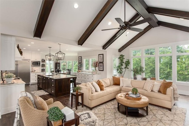 living room featuring hardwood / wood-style flooring, high vaulted ceiling, a healthy amount of sunlight, and sink