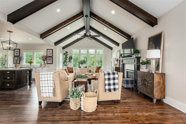 living room with vaulted ceiling with beams, dark hardwood / wood-style floors, and ceiling fan with notable chandelier