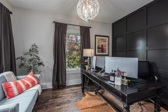 home office with a notable chandelier and dark hardwood / wood-style floors