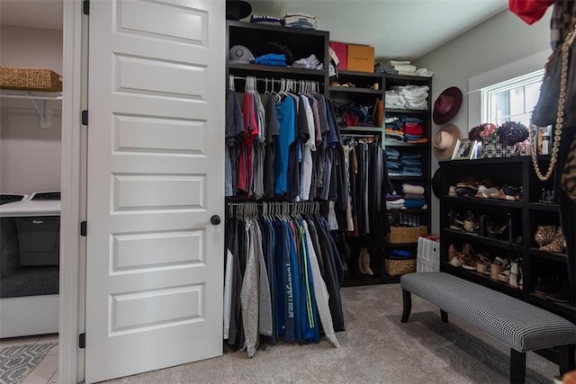 walk in closet featuring carpet flooring and washer / clothes dryer