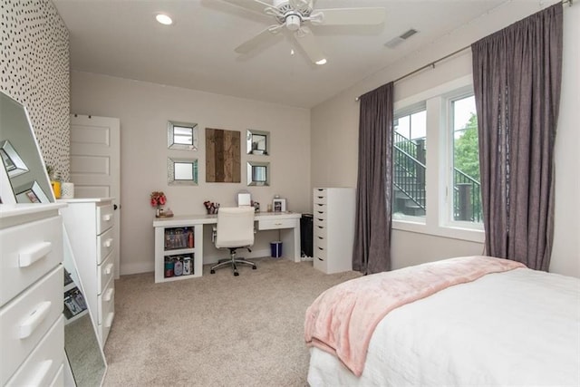 bedroom featuring light colored carpet and ceiling fan