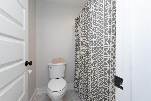 bathroom with toilet and tile patterned floors