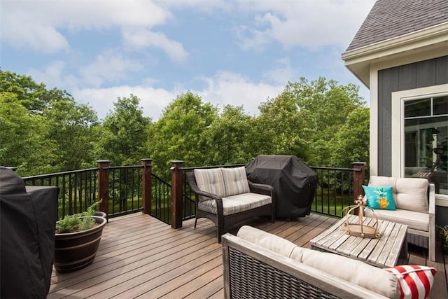 wooden terrace featuring a grill and an outdoor hangout area