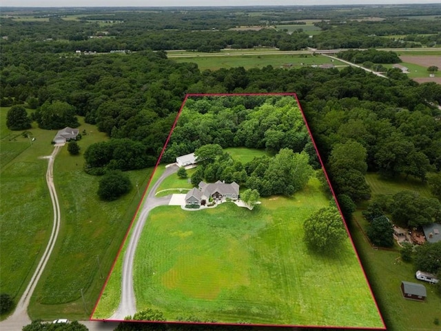 birds eye view of property with a rural view