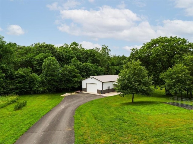 view of front of home with a front yard and a garage