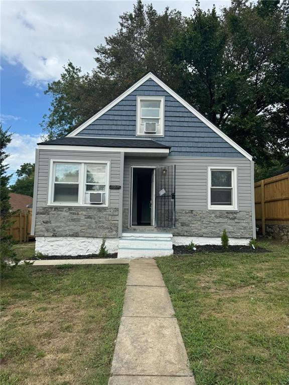 bungalow-style home with a front yard