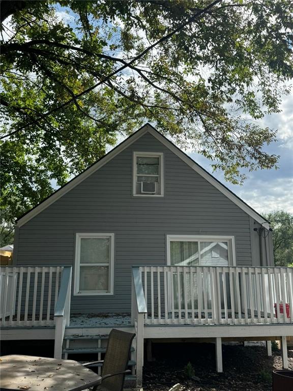 back of house featuring a deck