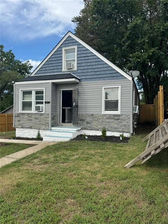 bungalow-style home featuring a front yard