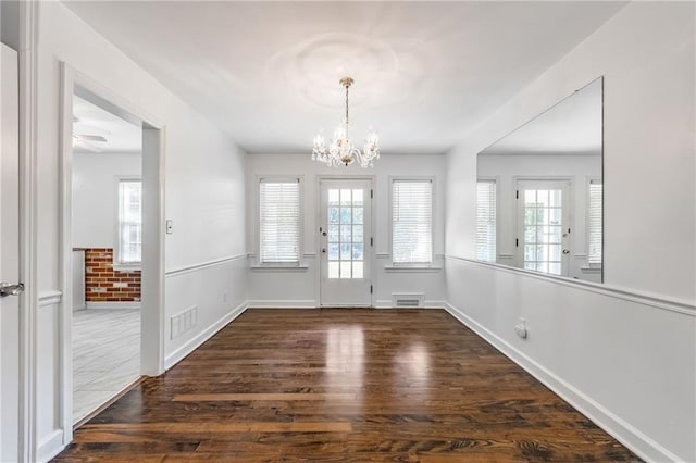 entryway featuring a notable chandelier and dark hardwood / wood-style flooring