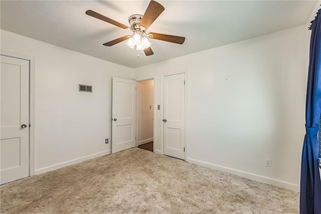 unfurnished bedroom featuring ceiling fan and light colored carpet