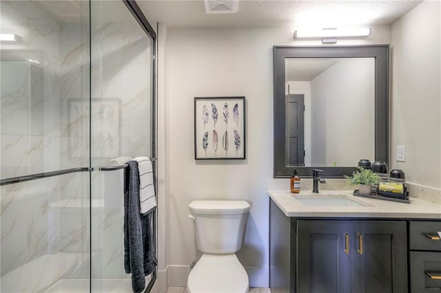 bathroom featuring a textured ceiling, walk in shower, vanity, and toilet