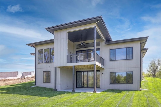 back of house with a balcony, a yard, and a patio area