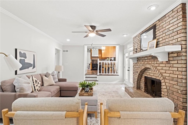 living room featuring a fireplace, ceiling fan, and crown molding