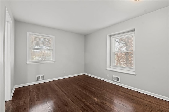 unfurnished room with plenty of natural light and hardwood / wood-style flooring