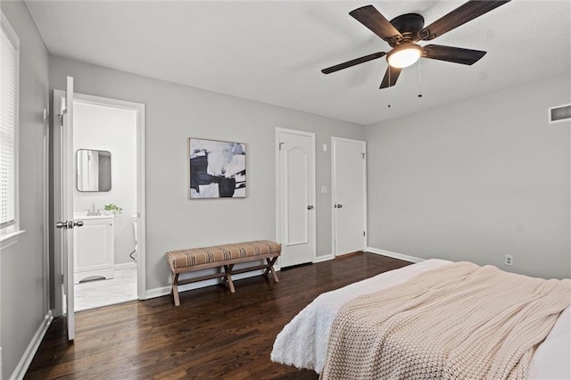 bedroom with ceiling fan, sink, dark wood-type flooring, and ensuite bath