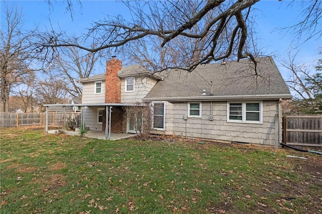 back of house featuring a yard and a patio