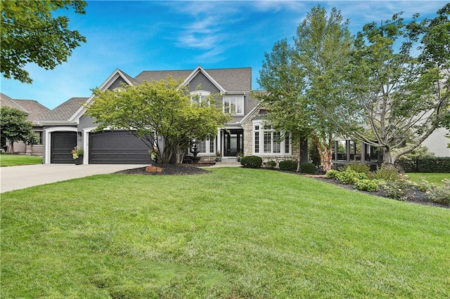 view of front facade featuring a garage and a front lawn