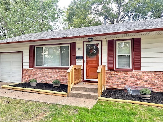 doorway to property with a garage