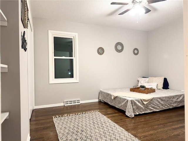 bedroom featuring dark hardwood / wood-style flooring and ceiling fan