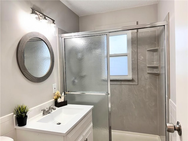 bathroom with vanity, toilet, and an enclosed shower