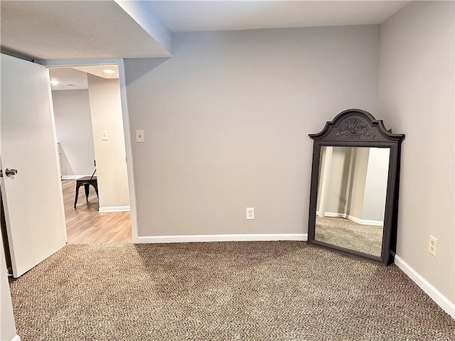 unfurnished room featuring carpet