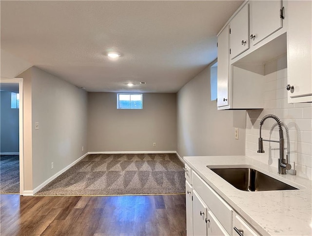 kitchen with sink, white cabinetry, decorative backsplash, and dark hardwood / wood-style floors