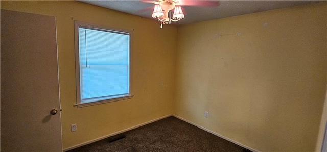 carpeted spare room featuring ceiling fan