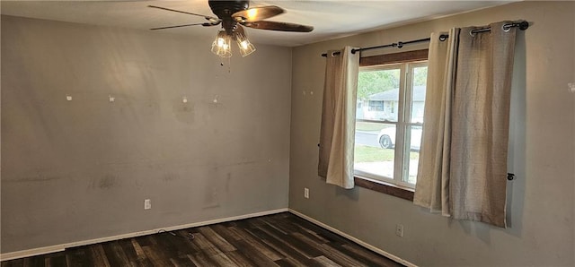 empty room featuring ceiling fan and dark wood-type flooring