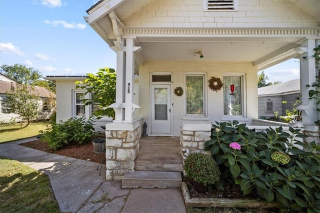 view of exterior entry with a porch