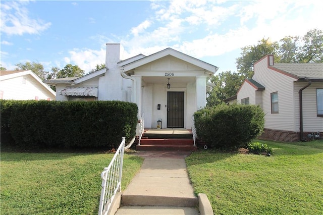 bungalow-style house with a front yard