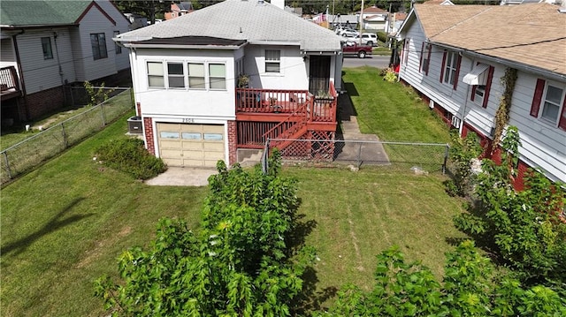 back of property featuring a garage and a yard