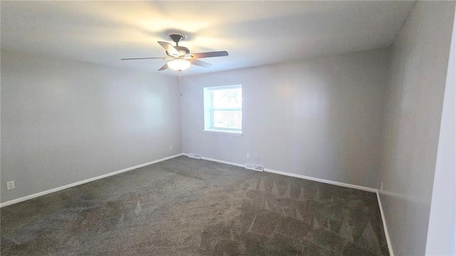 empty room featuring dark colored carpet and ceiling fan