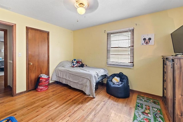 bedroom with ceiling fan and light hardwood / wood-style flooring