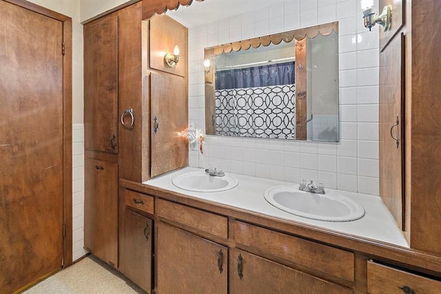 bathroom featuring vanity, tile walls, tasteful backsplash, and curtained shower