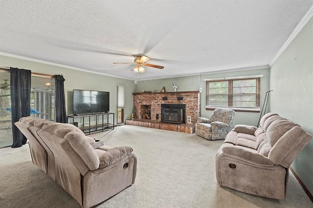 living room with a brick fireplace, a textured ceiling, crown molding, ceiling fan, and light carpet