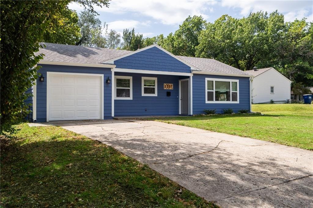 ranch-style home featuring a garage and a front yard