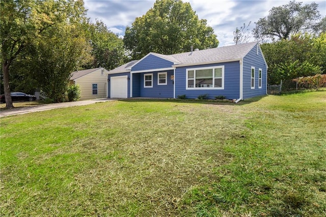 single story home with a front yard and a garage