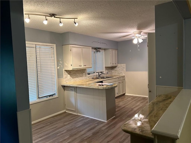 kitchen with decorative backsplash, white cabinetry, dark hardwood / wood-style flooring, a textured ceiling, and ceiling fan