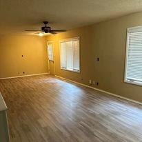 unfurnished room featuring a wealth of natural light, ceiling fan, and hardwood / wood-style flooring